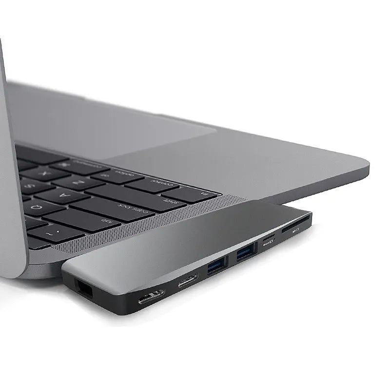 An 8-in-1 USB-C hub with dual plugs for MacBook Pro, showing USB, HDMI, and card reader ports.
