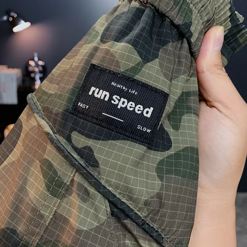 Men's loose fit camouflage cargo shorts with cargo pockets on a mannequin.