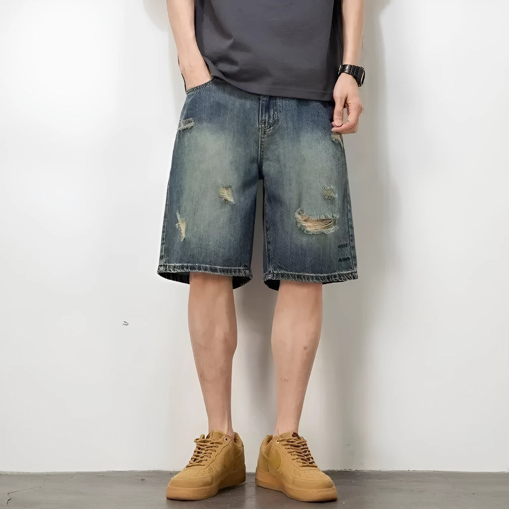 Blue retro-style men's denim shorts with a straight leg and slight distressing details on a neutral background.