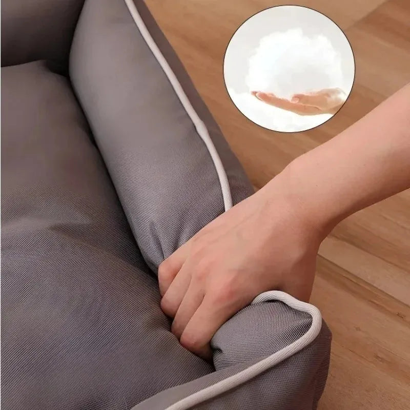 Grey raised cushion dog sofa bed with a waterproof Oxford cloth cover on a wooden floor.