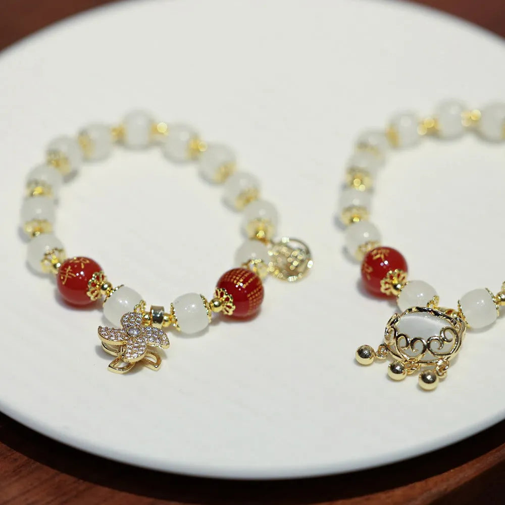 Chinese style coloured glaze bracelet with glass safety lock charms and windmill bead design