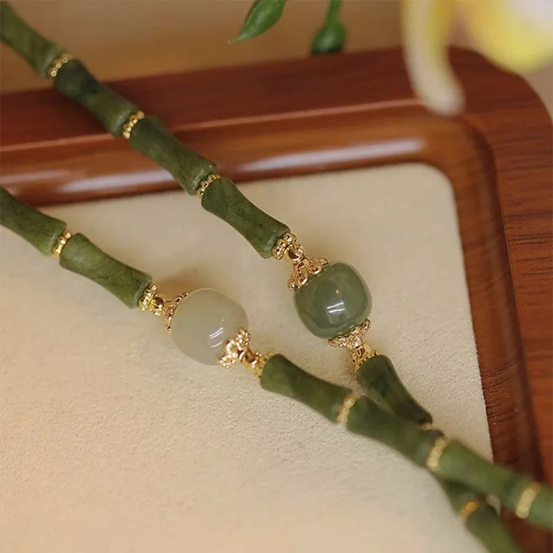 A simple geometric Hetian jade bracelet for women with a Yuan dynasty smoked design, shown in dark green.