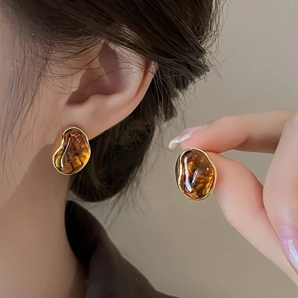 Handmade holiday earrings with three geometric styles: round, irregular, and water drop designs with tassel elements