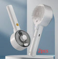 Ceramic white pet grooming comb with soft needles, UVC blue light, and a mist spray nozzle.