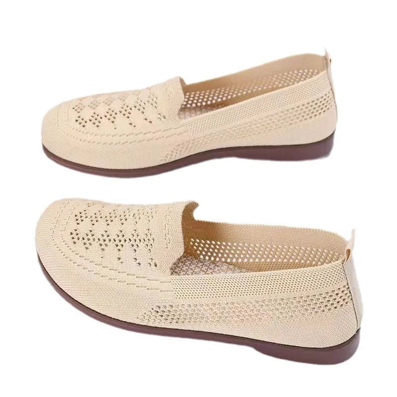Beige low-top mesh tennis shoes for women with wide feet, showing breathable upper and flat PVC sole.