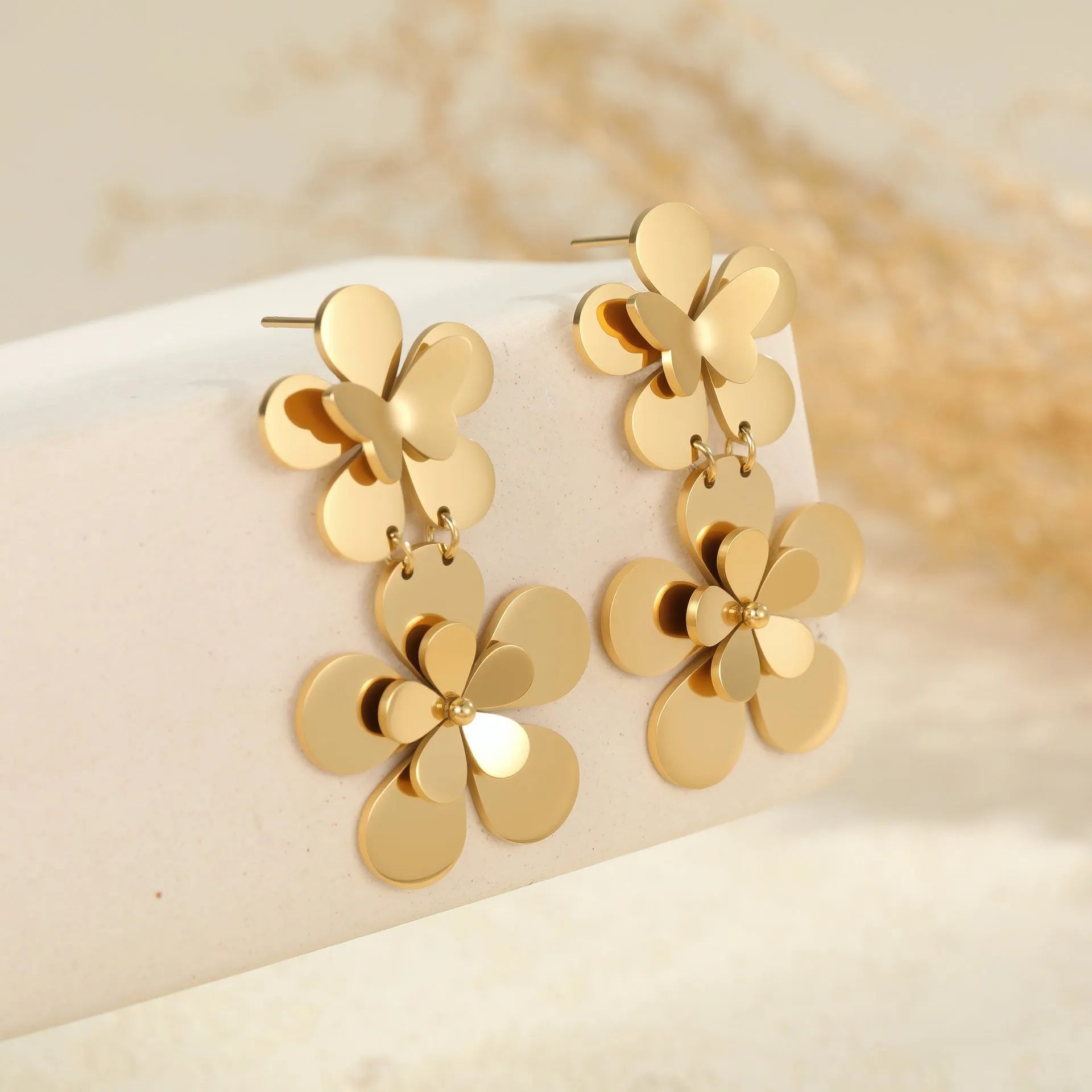 Gold-coloured stainless steel women's earrings with butterfly and flower geometric design