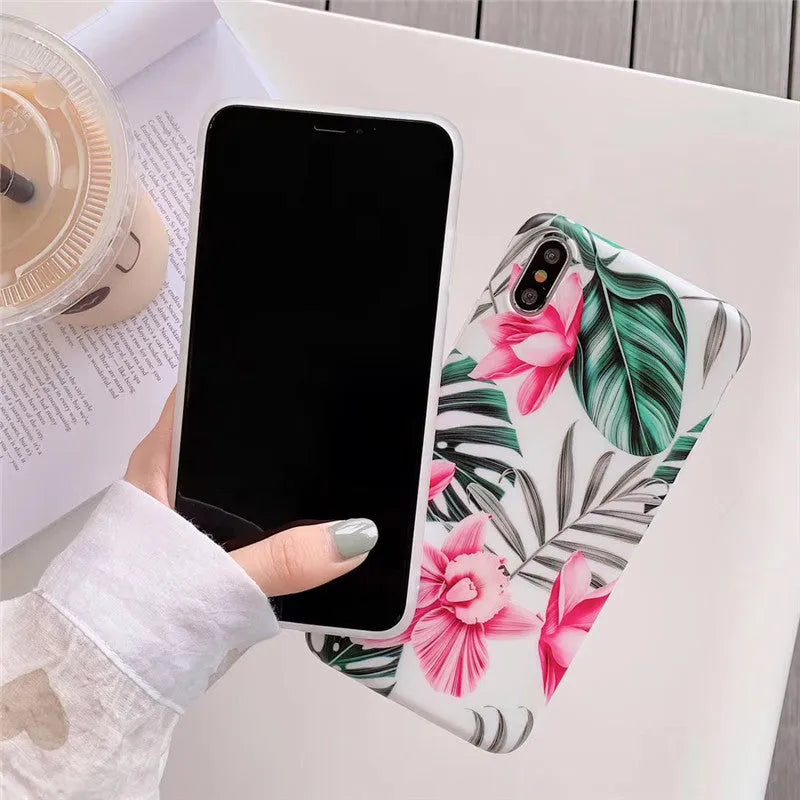 Pink flower design TPU phone case for iPhone on a table.