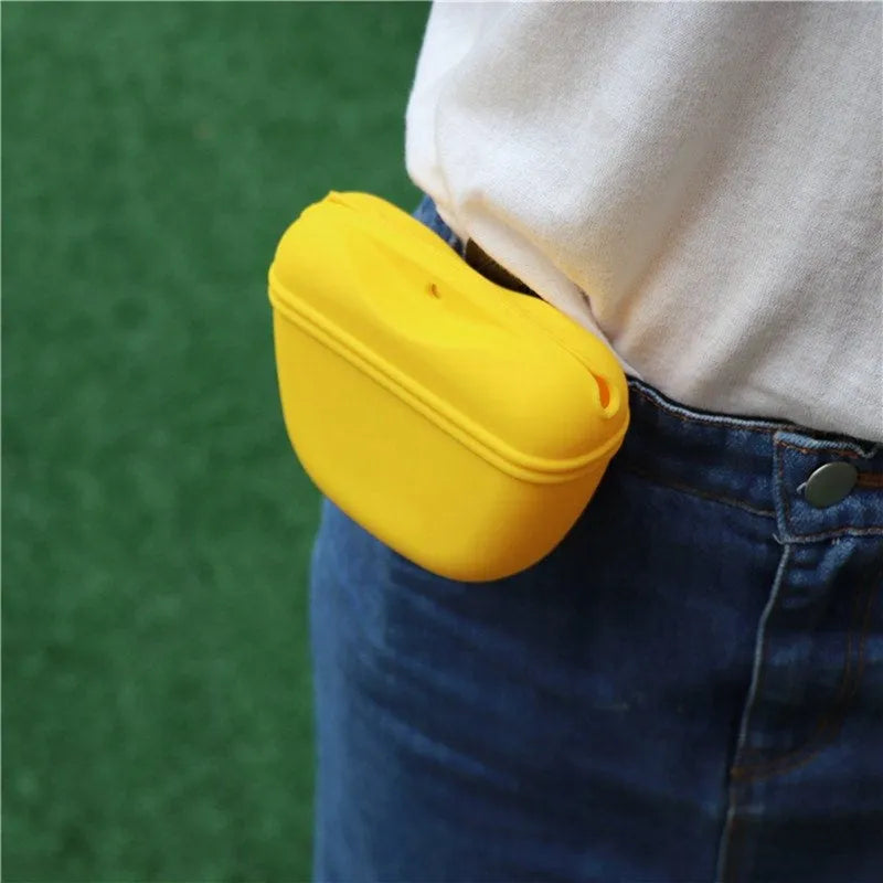 Silicone dog treat bag with magnetic closure measuring 12.5cm long, shown attached to belt with treats visible inside