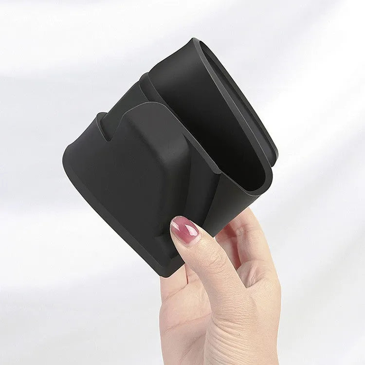 Black silicone sunglasses case installed inside a Tesla Model 3 or Y centre console armrest.