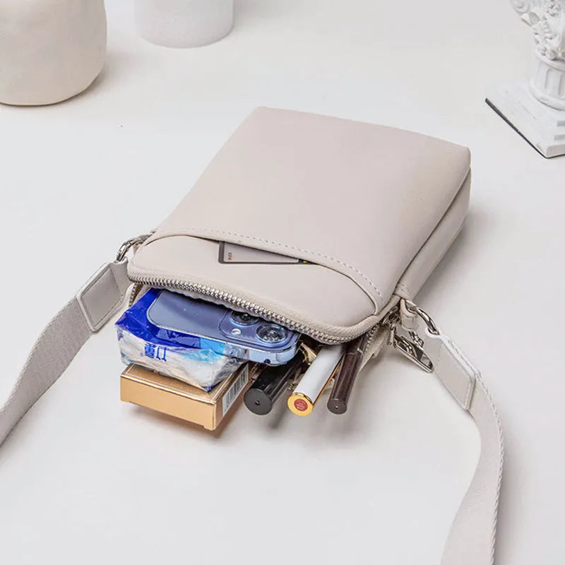 Solid colour mobile phone crossbody bag with adjustable strap, compact 14.5x5.5x19cm dimensions