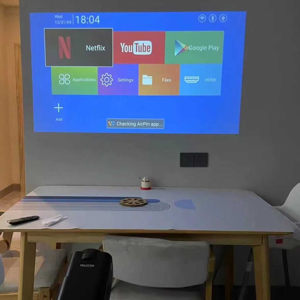 A wireless home gaming projector with a carry handle, showing a 720p HD display on a wall.