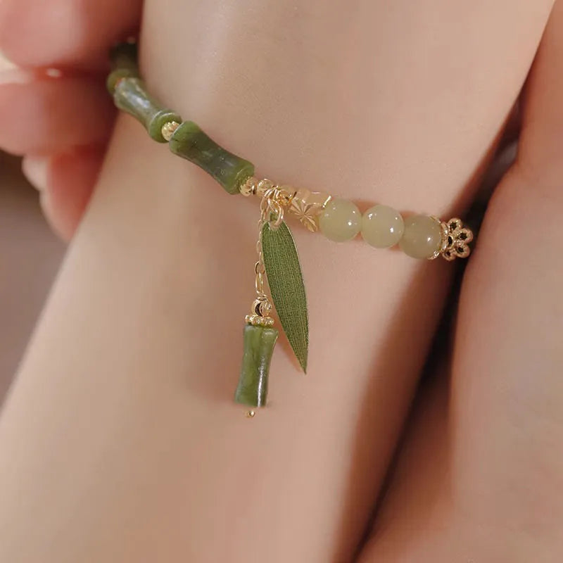 Chinese style bamboo leaf bracelet for women in glass with bamboo joint elements, showing manual processing and colour variations