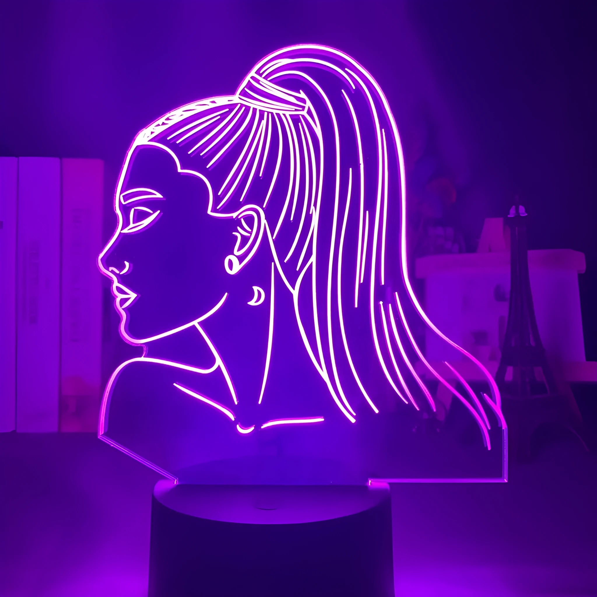 Slim acrylic 3D night light with LED illumination on a table.