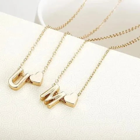 Peach heart shaped letter necklace pendant in gold or silver alloy, weighing 5.5g.