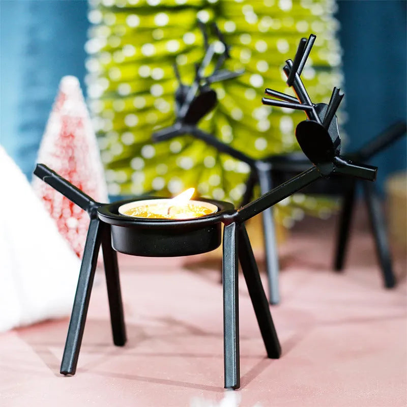 Black iron Christmas deer candlestick holder with Santa and snowman designs, 15cm height