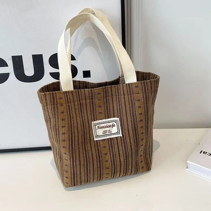 Japanese style large capacity corduroy handbag in dark brown, shown front view.