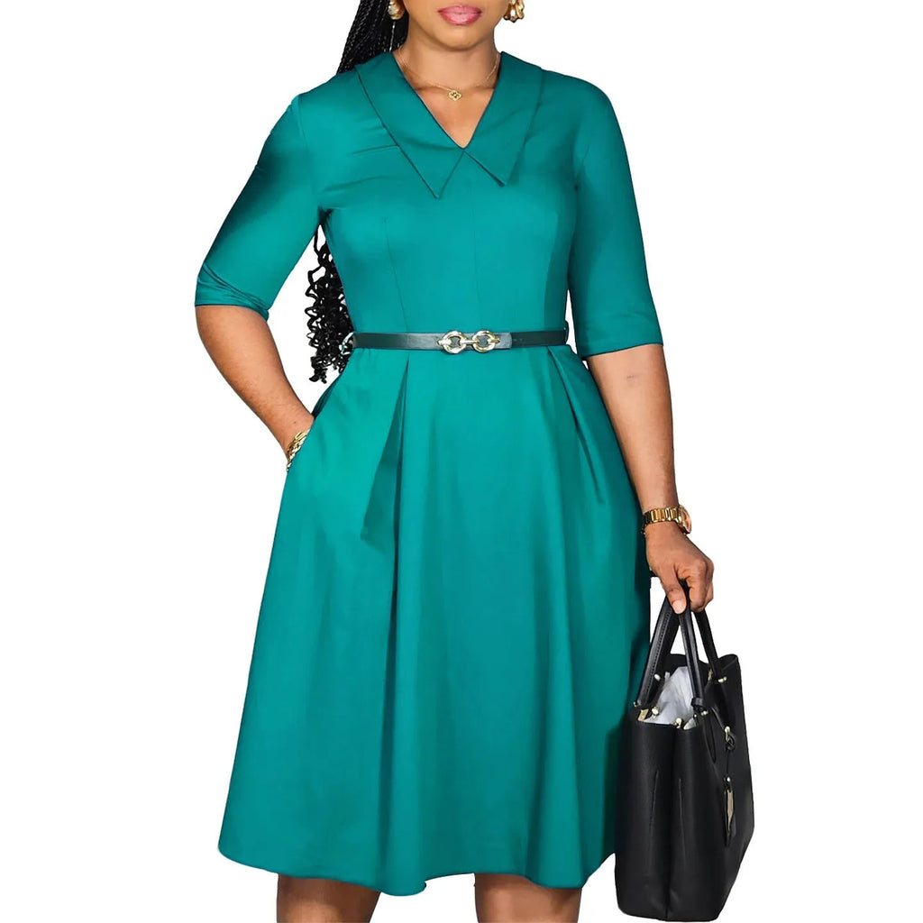 Women's solid colour African dress with high waist, half sleeves, and a matching belt.