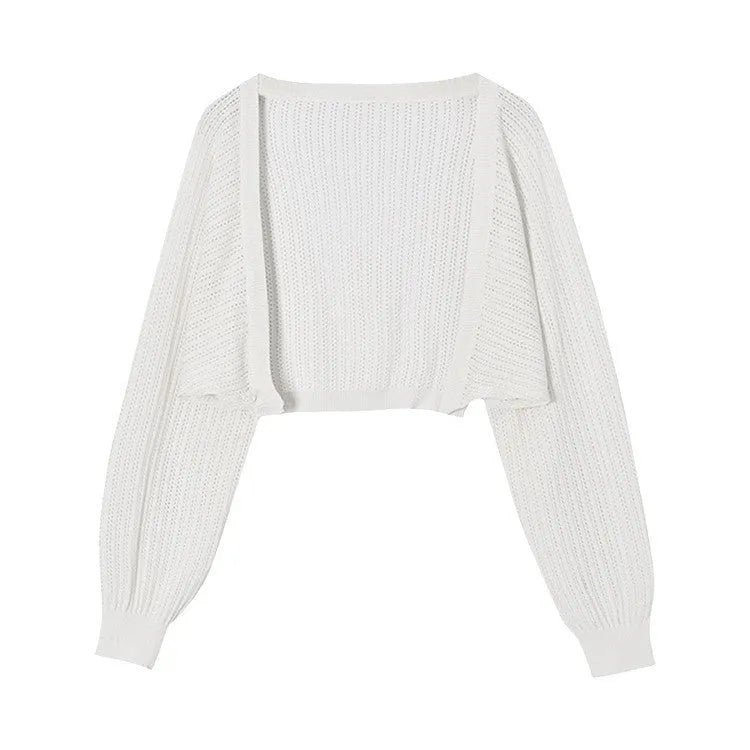Women's apricot coloured blouse with long, loose lantern sleeves and hollow-out fabric detail.