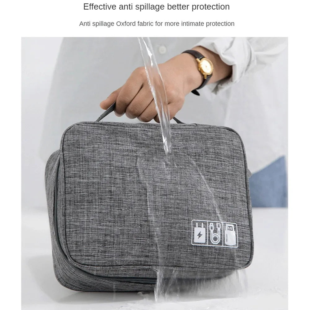 Black electronics organiser bag with mesh pockets and removable dividers for cable storage