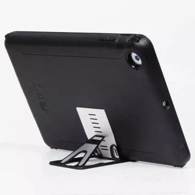 Black desktop phone holder with suction cup base showing adjustable bracket for smartphones