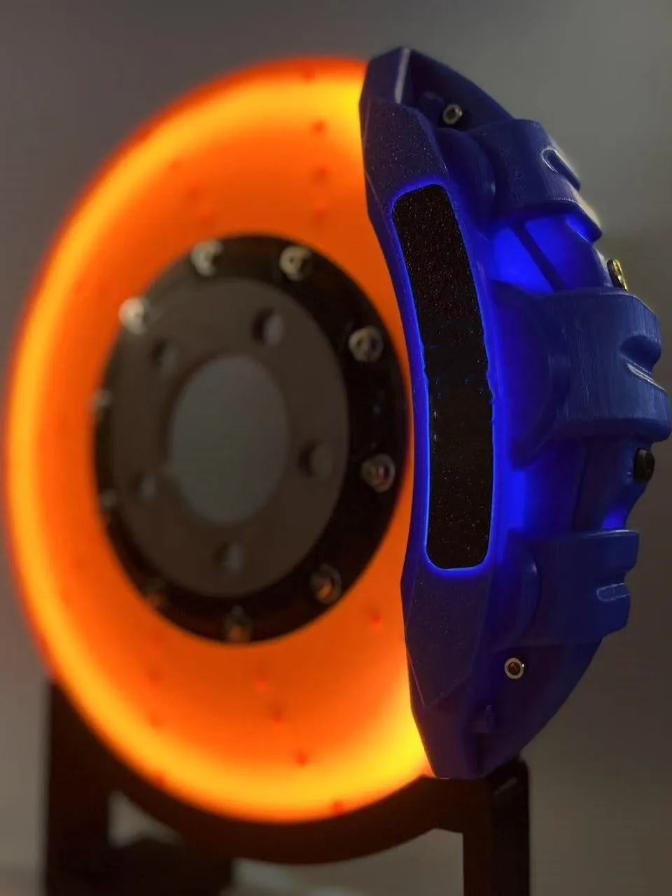 Blue brake disc LED rechargeable night light with touch dimmer on a desktop