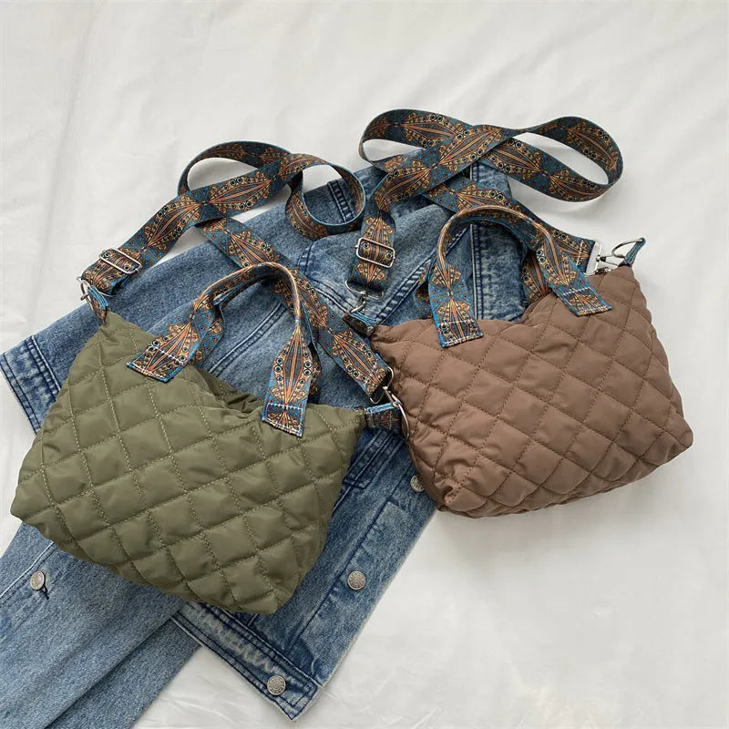 A soft oxford cloth shoulder messenger bag in a horizontal square shape with a single strap.