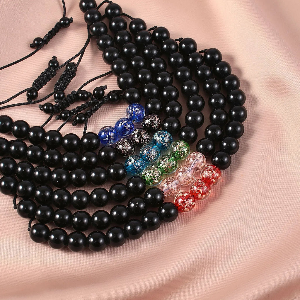 Geometric adjustable bracelet with luminous glass beads in sapphire blue on a wrist.