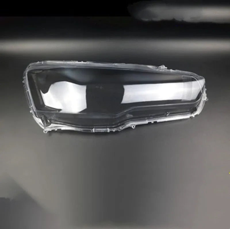 Transparent plastic automotive headlight housing cover showing clear construction