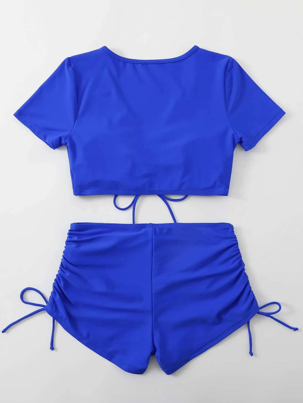 Lady in dark green lace-up bow swimsuit with matching shorts, adjustable front tie.