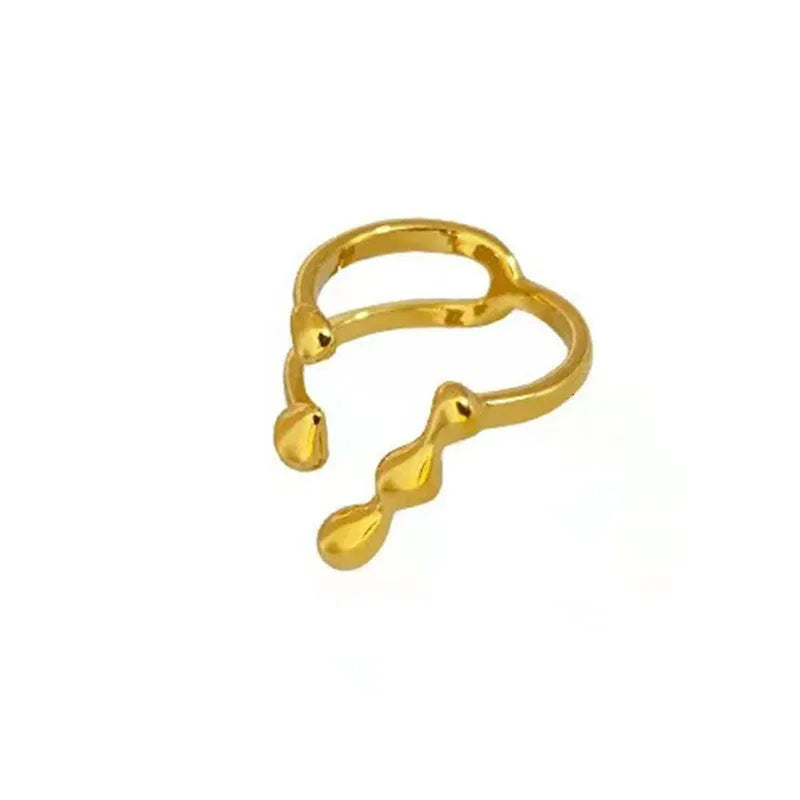Adjustable brass fashion ring with spherical design in gold finish on hand