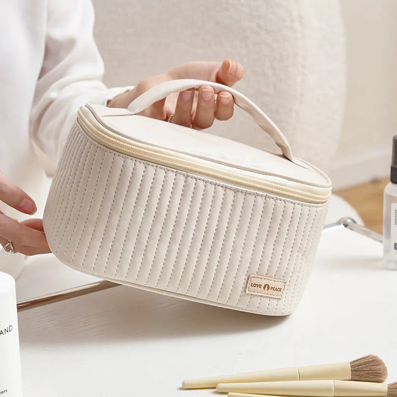 Open-top pink PU leather makeup bag showing interior space for cosmetics organisation