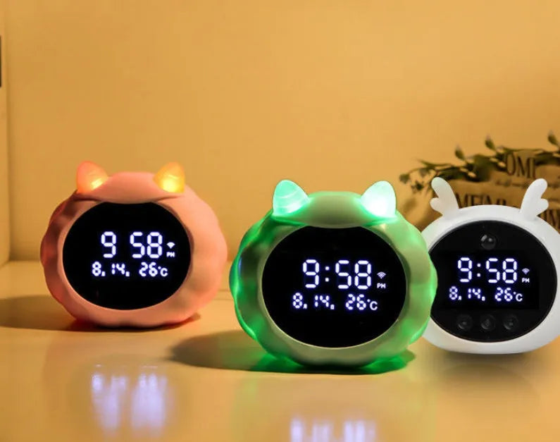 White Deer style smart alarm clock with digital display, silicone shell, and power cord.