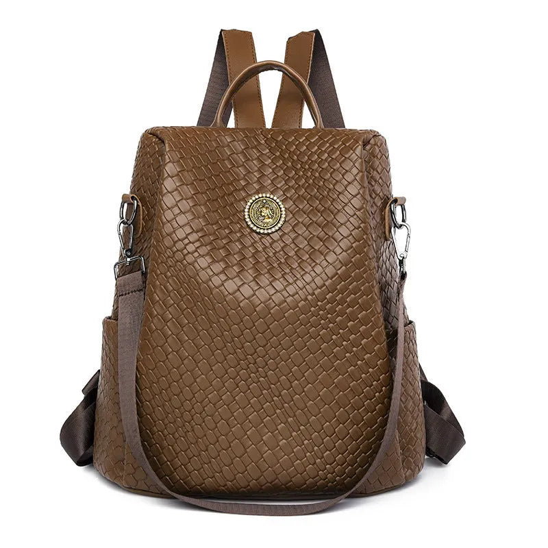 Women's black waterproof anti-theft backpack showing woven detailing and organisational compartments