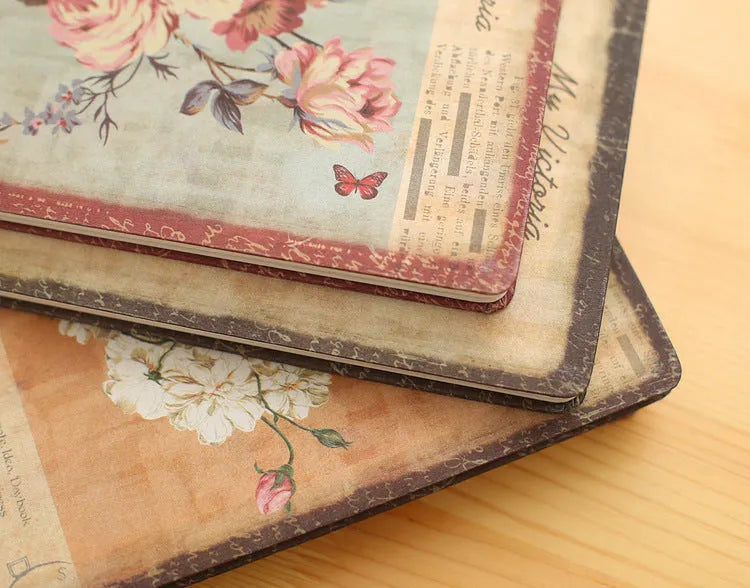Hardcover notebook with cloth cover showing retro floral pattern in either lily, peony or white rose design
