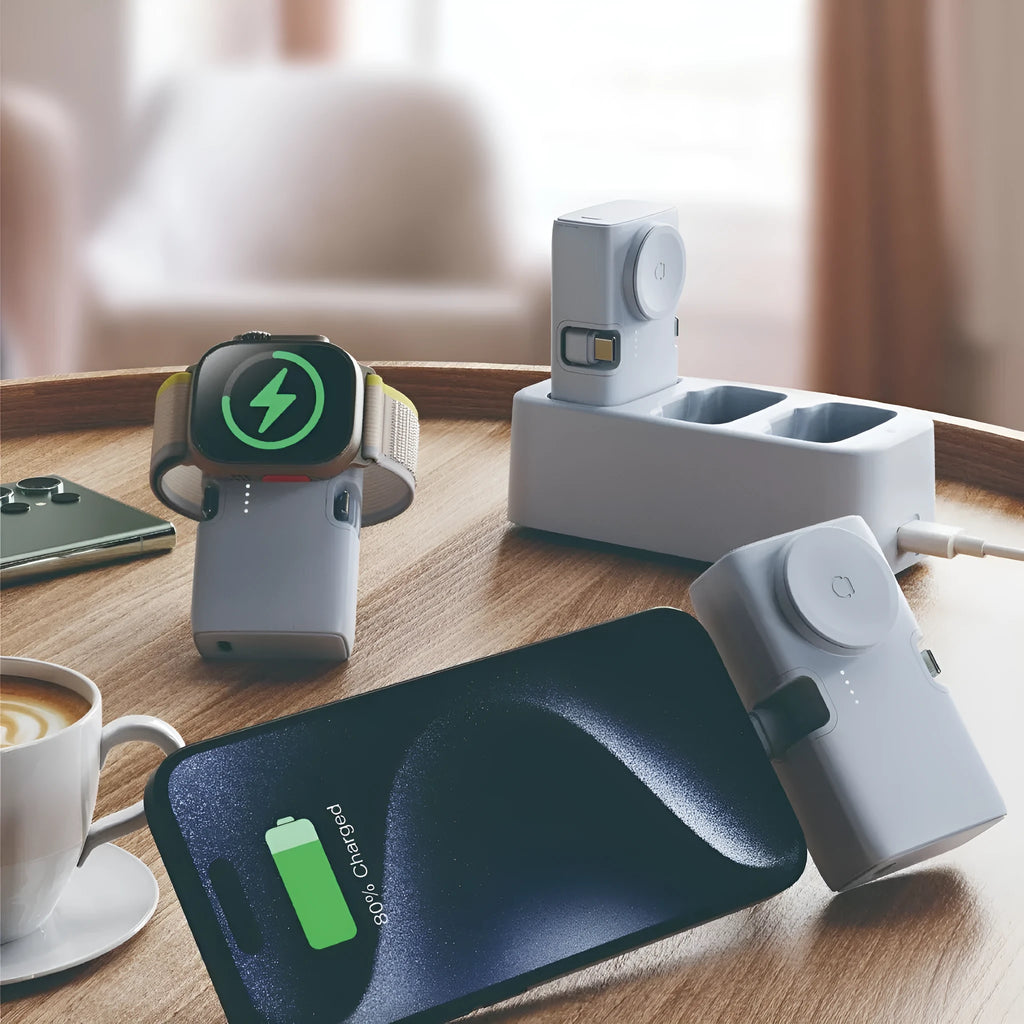 Compact white plastic wireless power bank with 5000mAh capacity, shown next to a smartphone.