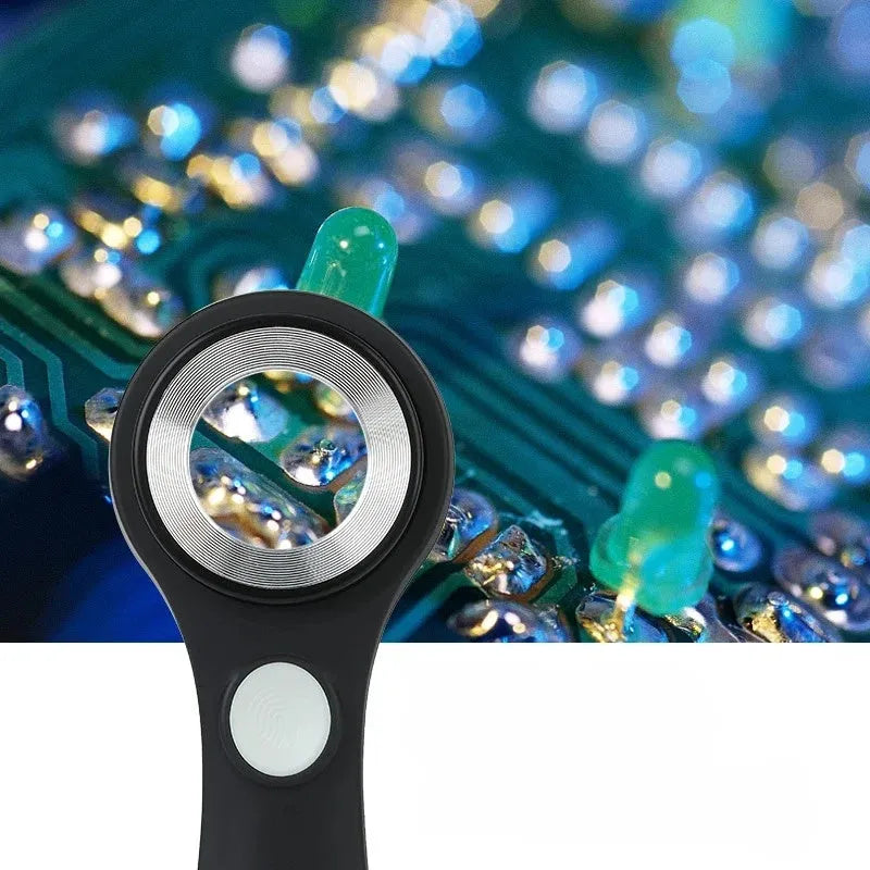 Black and silver jewellery appraisal magnifying glass with optical glass lens and USB-C cable on a table.