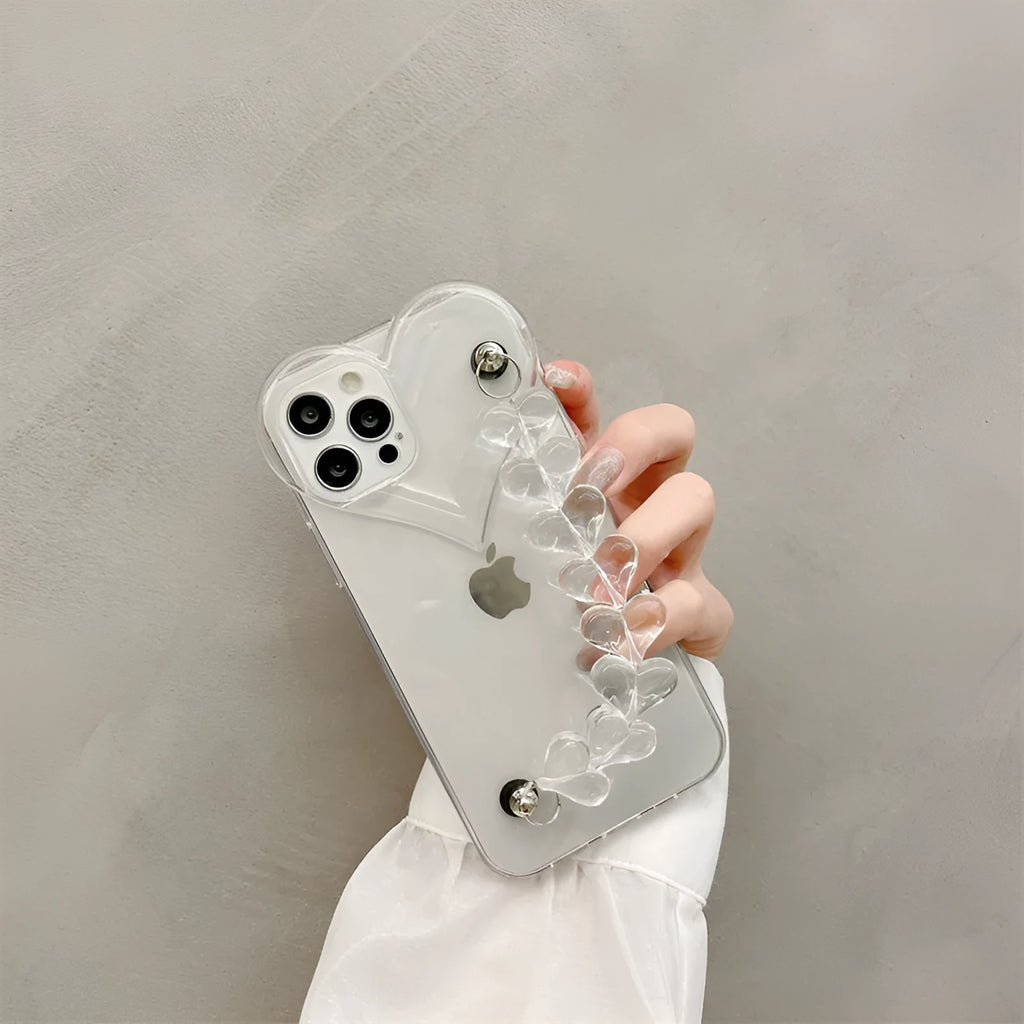 Transparent iPhone case with a soft TPU build and an integrated love heart chain, shown on a phone.