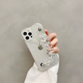 Transparent iPhone case with a soft TPU build and an integrated love heart chain, shown on a phone.