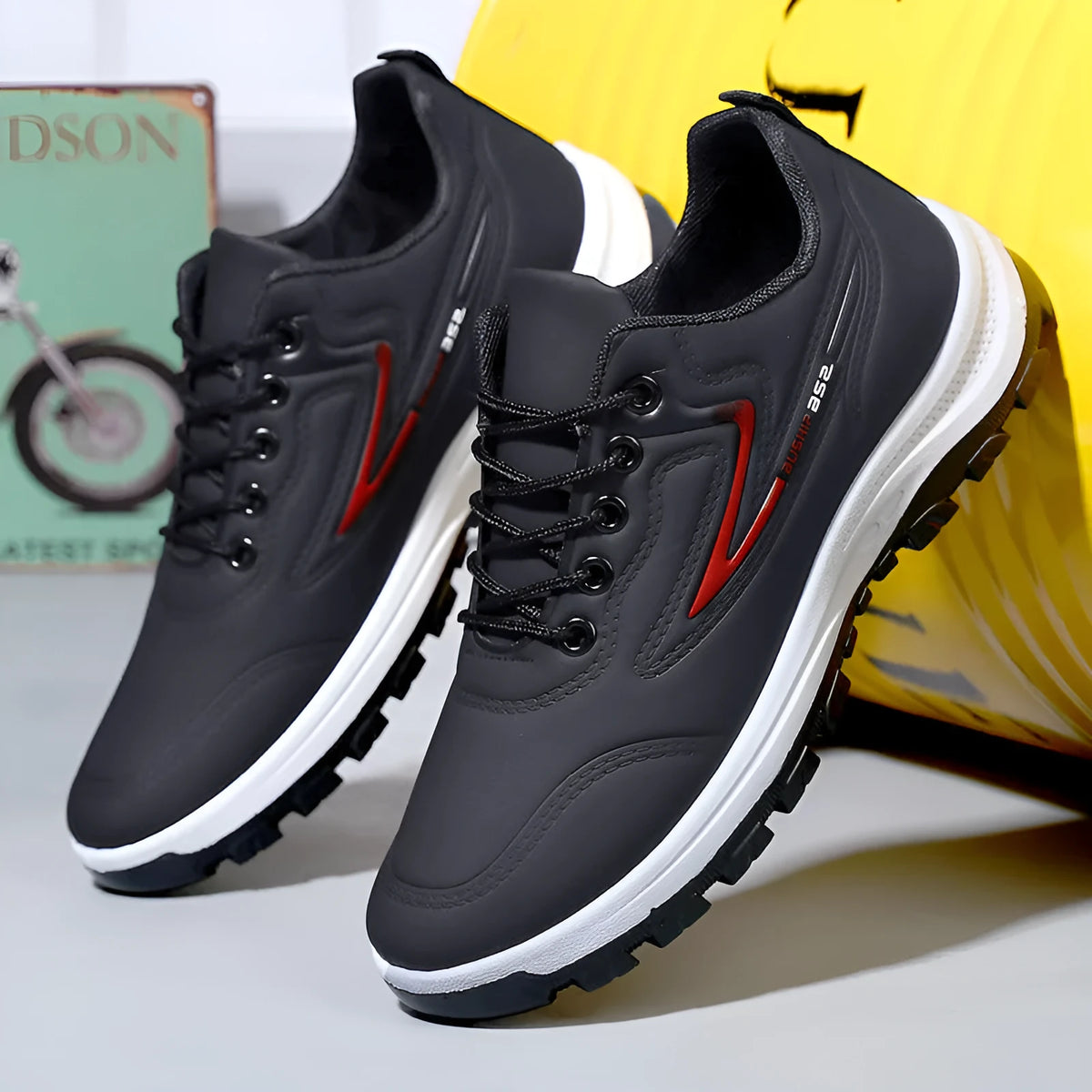 Waterproof casual sports shoes in black-grey colour with flat plastic sole and low-top design