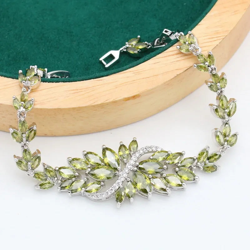 Retro jewellery set with botanical patterns in olive or purple, showing bracelet, necklace, earrings, and ring