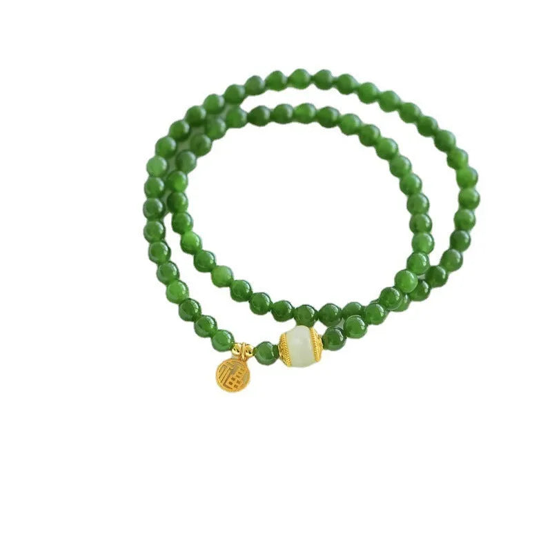 Women's double circle bracelet with natural Hetian jade beads and a central fu character charm.