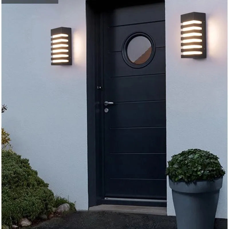 Modern minimalist layered aluminium outdoor wall lamp mounted on a wall.