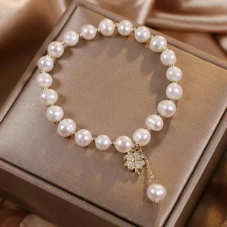 White freshwater pearl bracelet with four-leaf clover charm, alloy material, and sequin detail for women