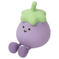 Cartoon-shaped eggplant night lamp glowing with soft yellow light on a table.