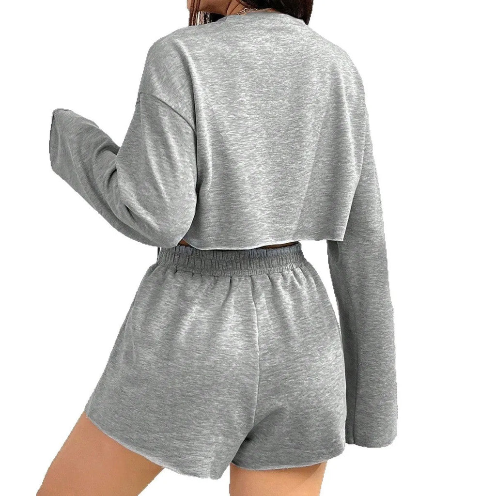Grey women's long-sleeved polyester top and shorts casual suit set laid flat.