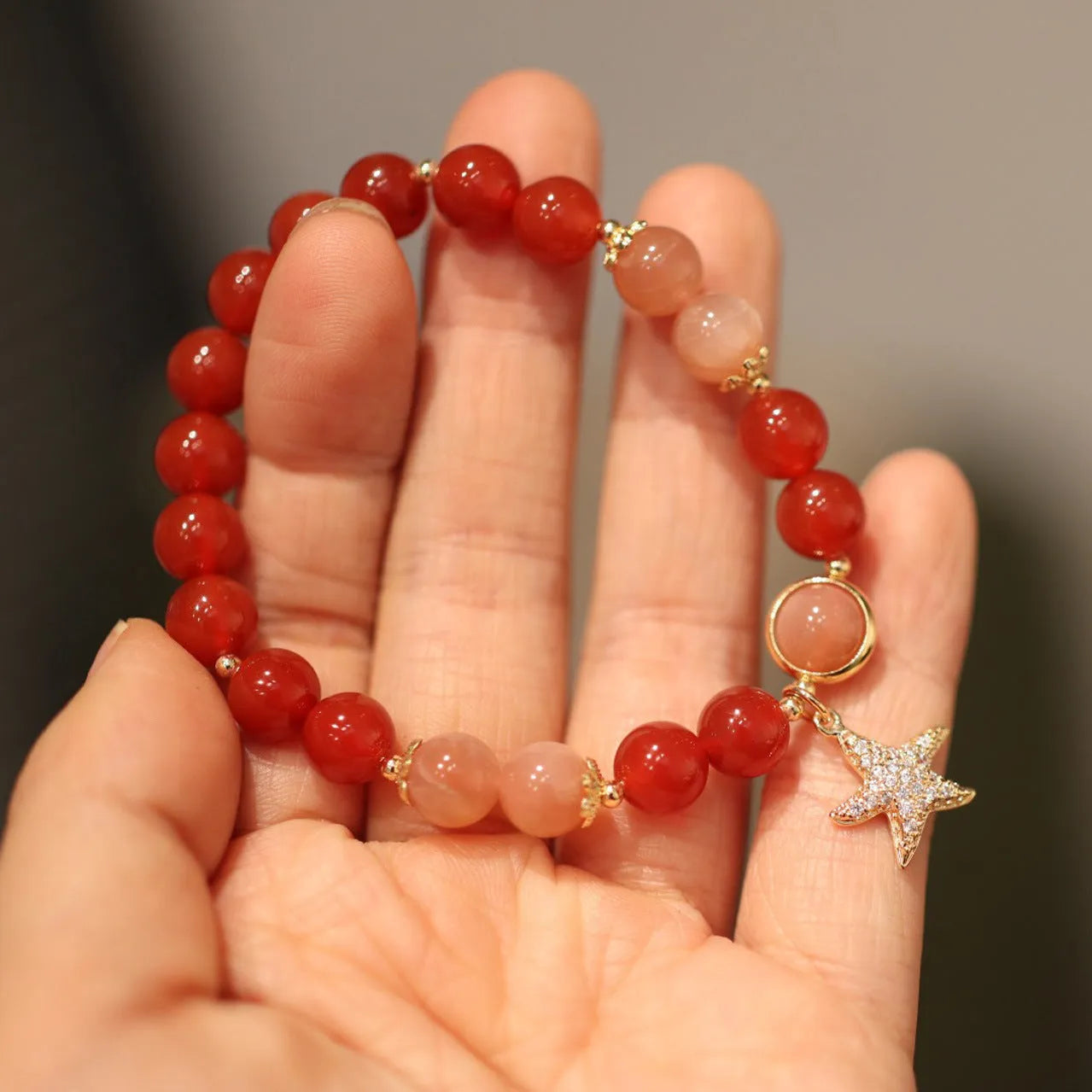 Handmade women's 8mm red agate and sunstone bracelet with xiangyun patterns in ethnic style