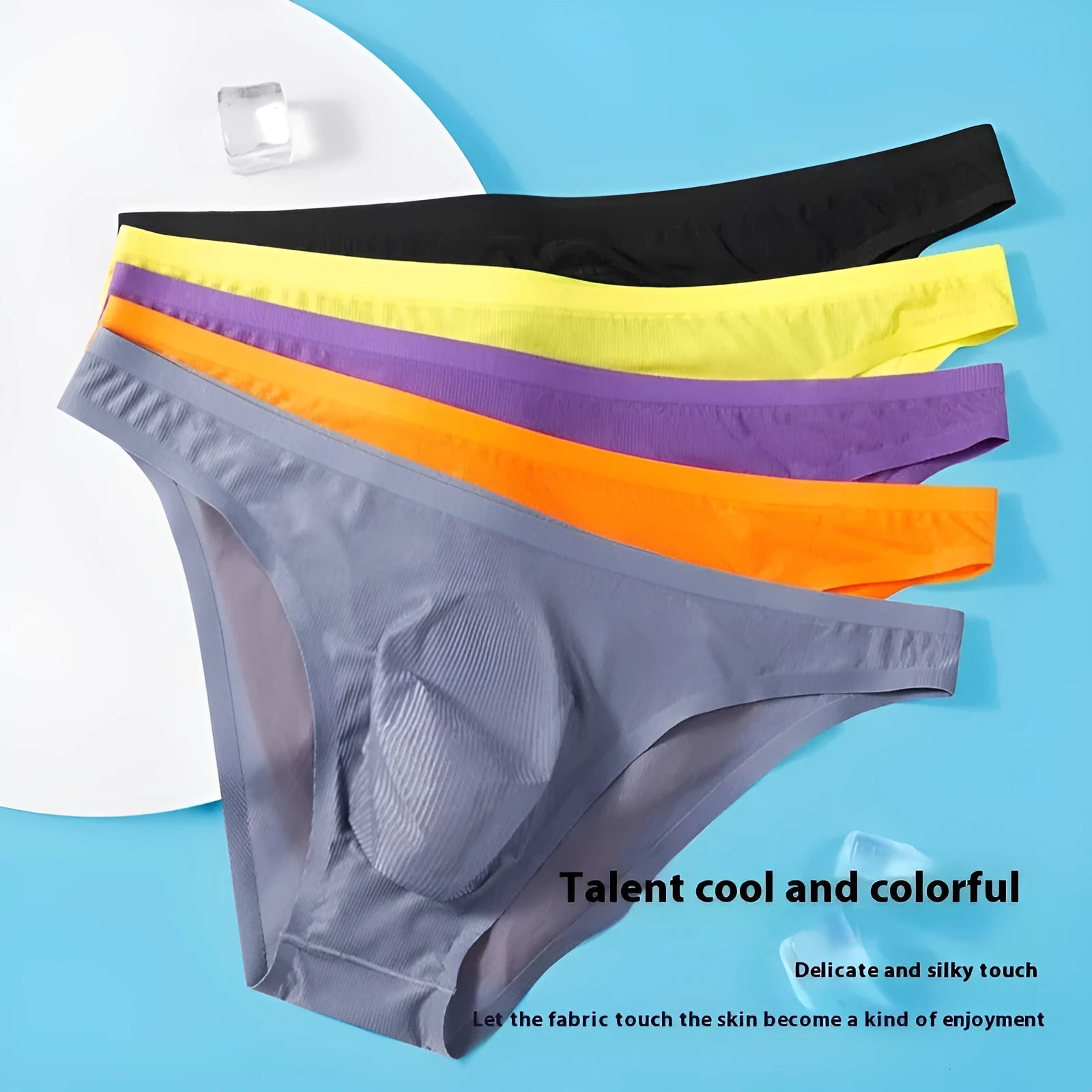 Men's black striped seamless ice silk underwear briefs laid flat, showing low waist and thin fabric.