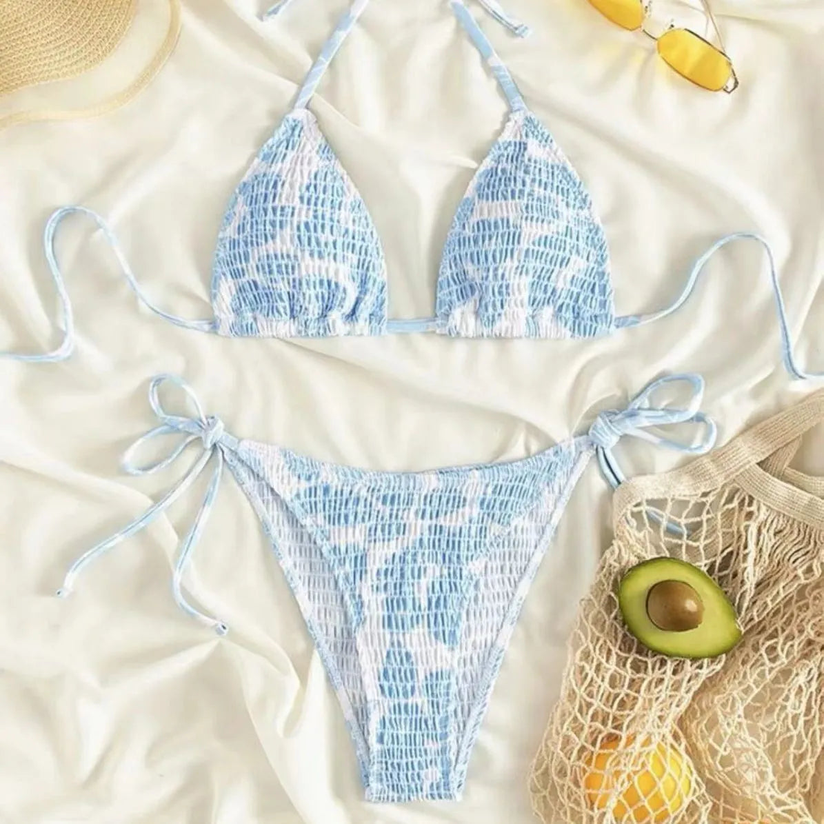Women's floral halter swimsuit one-piece in light blue polyester on a mannequin