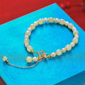 Women's Hetian jade bracelet with round pearl pendant in gold electroplated finish