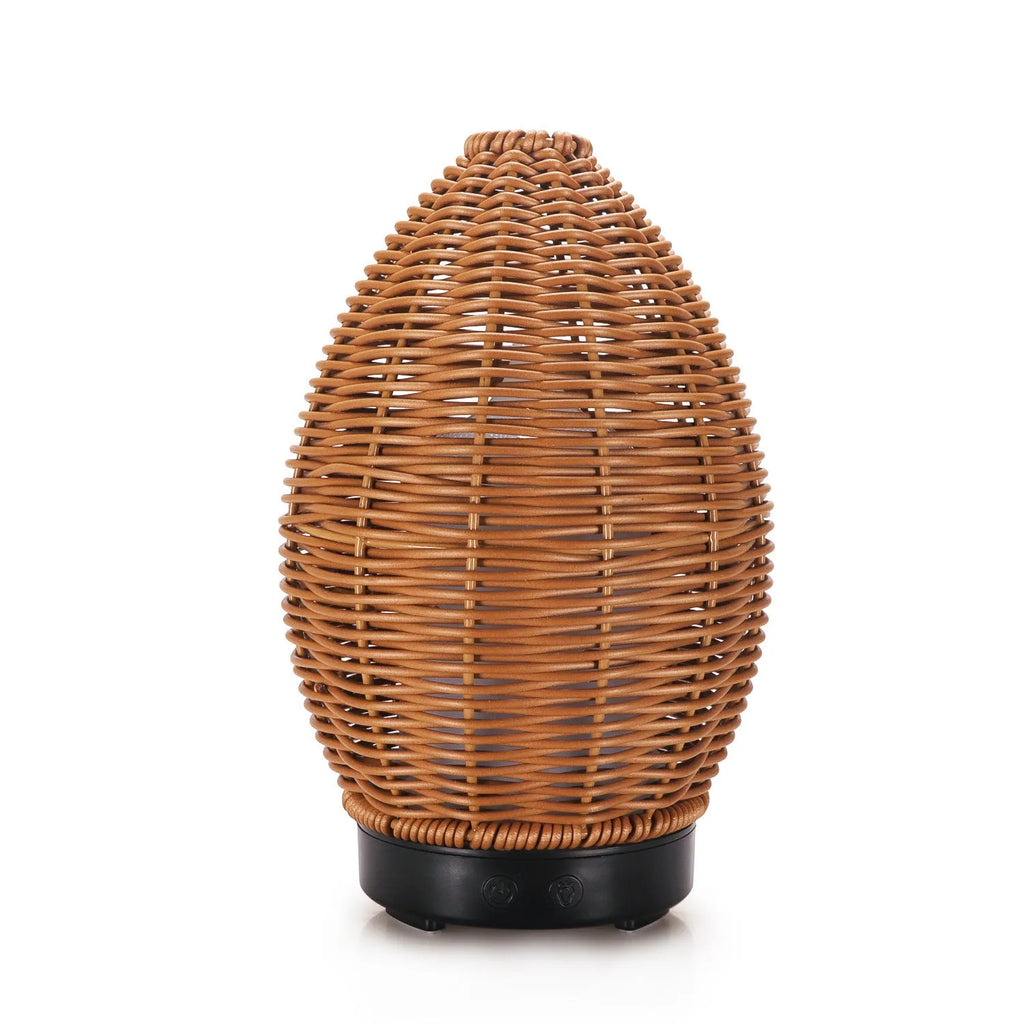 Light wood grain hollow rattan aroma diffuser with 100ml water tank on a wooden surface.